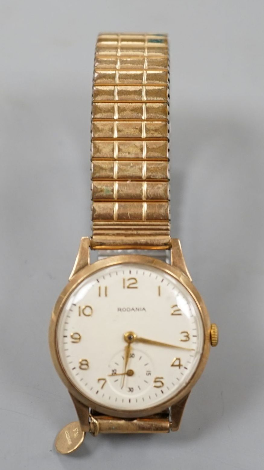 A gentleman's 9ct gold Rodania manual wind mid size wrist watch on associated gold plated expanding bracelet.